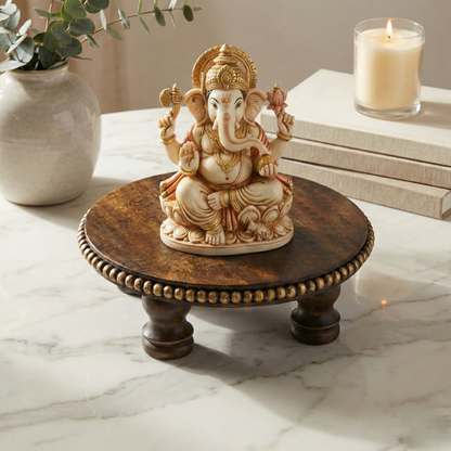 Handcrafted Lord Ganesha idol on wooden pedestal, home decor accent on marble table