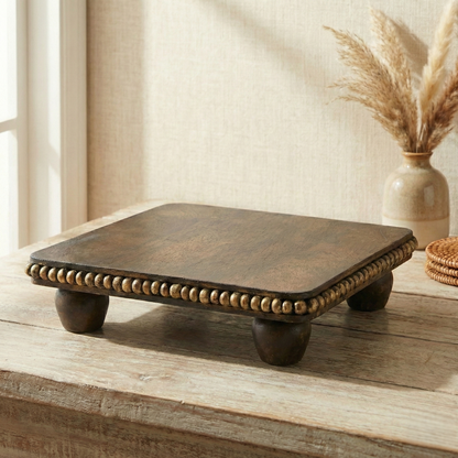 Handcrafted wooden decorative pedestal with beaded edge on rustic table, home decor accent