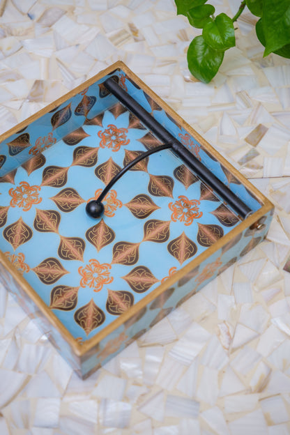 Handcrafted floral pattern napkin holder with blue and gold design on mother of pearl surface