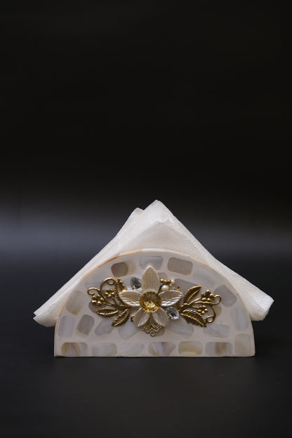 Handcrafted mother of pearl napkin holder with gold floral accents on black background