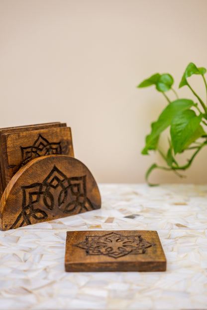 Handcrafted wooden coasters with floral engravings on a table, indoor decor