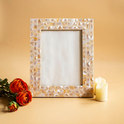 Mother of pearl photo frame with mosaic pattern, styled with orange flowers and candles