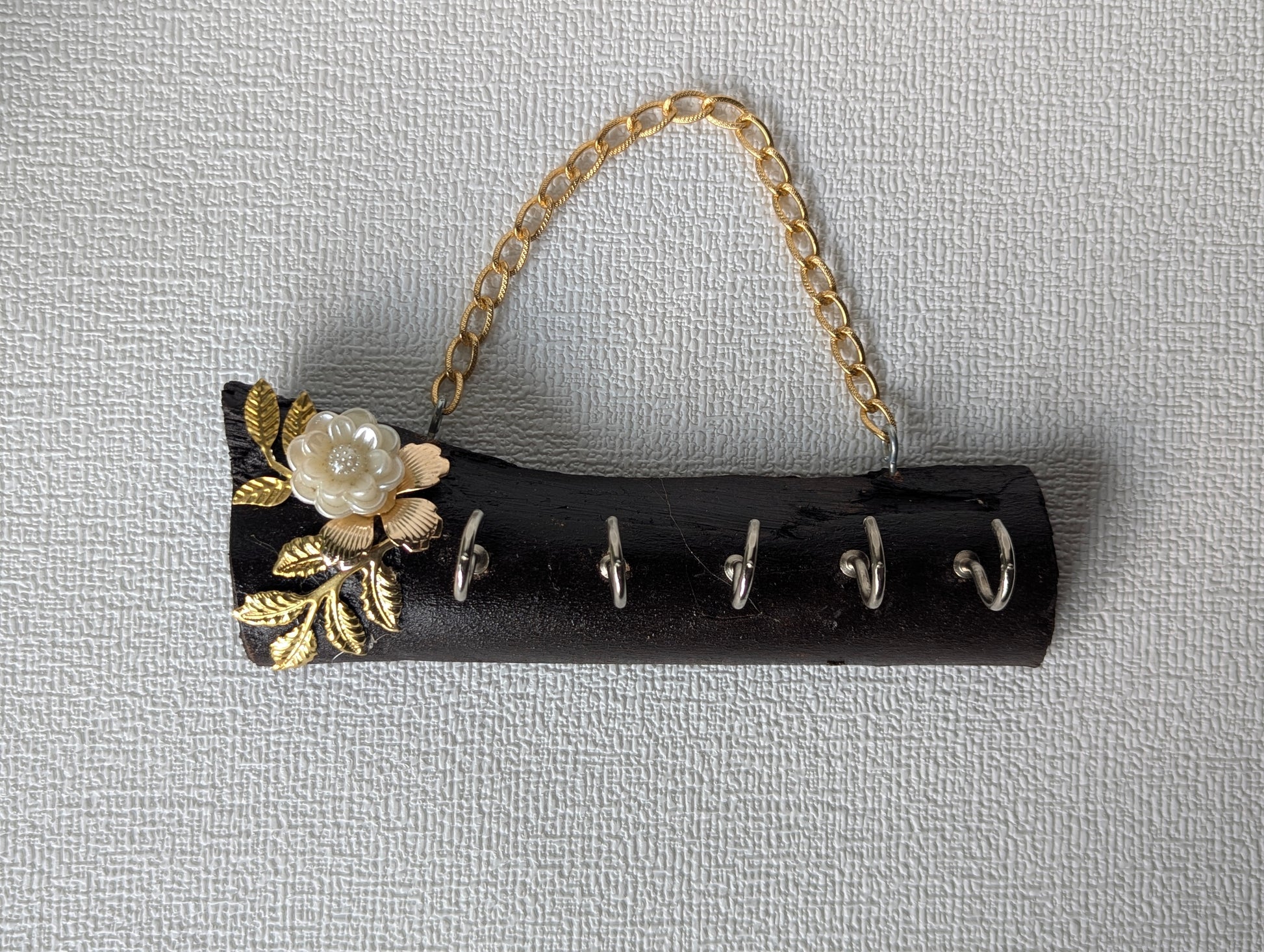 Handcrafted wooden key holder with gold leaf and Mother of Pearl flower accent