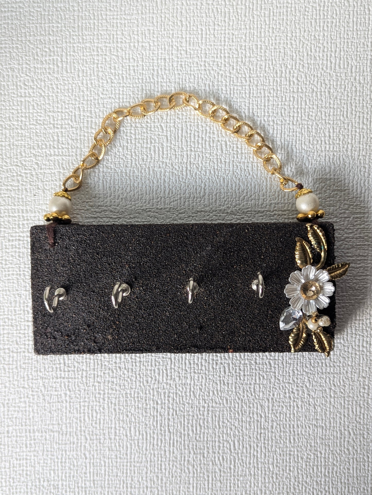 Handcrafted wooden key holder with floral embellishment and gold chain, Indian home decor