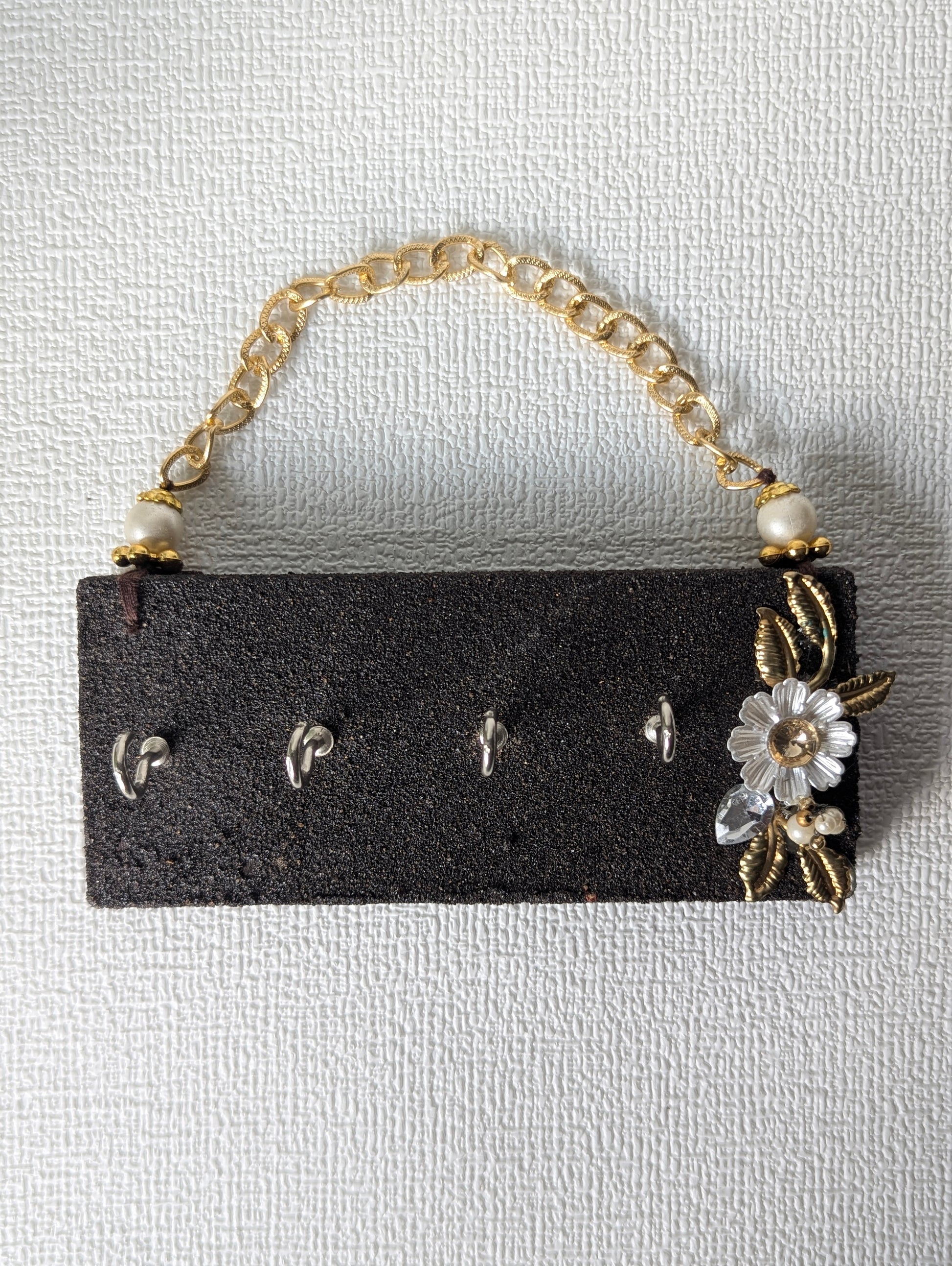 Handcrafted wooden key holder with floral embellishment and gold chain, Indian home decor