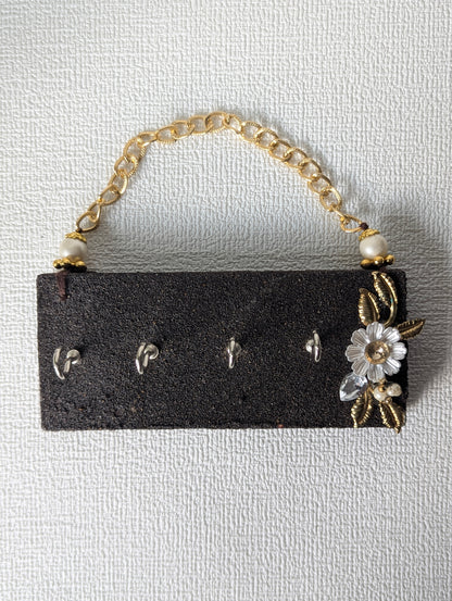 Handcrafted wooden key holder with floral embellishment and gold chain, Indian home decor