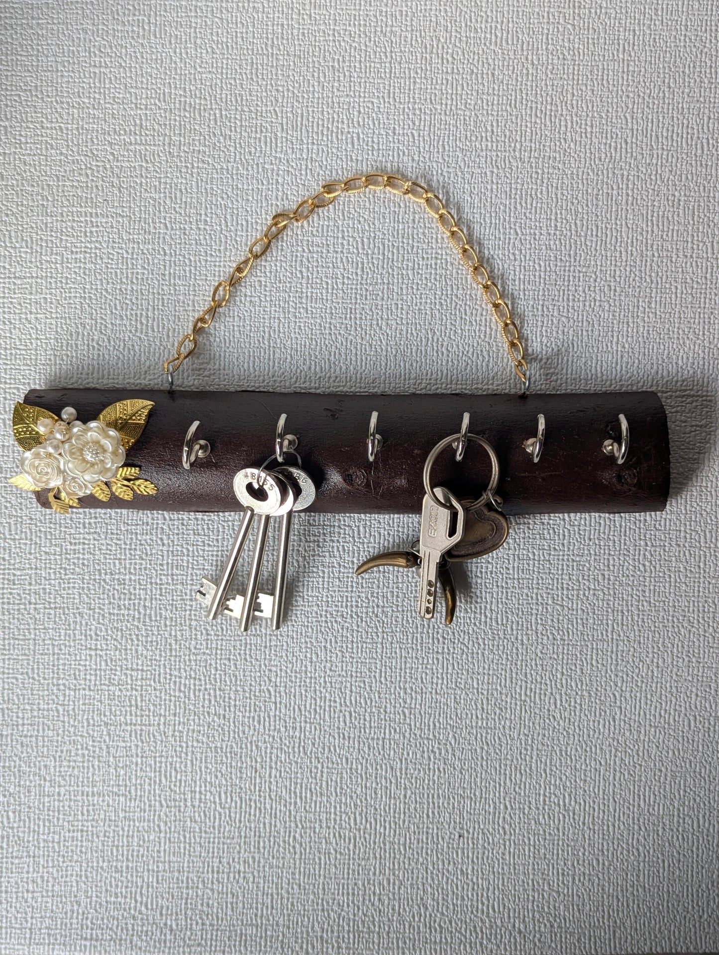 Handcrafted wooden key holder with floral Mother of Pearl decor and hanging keys