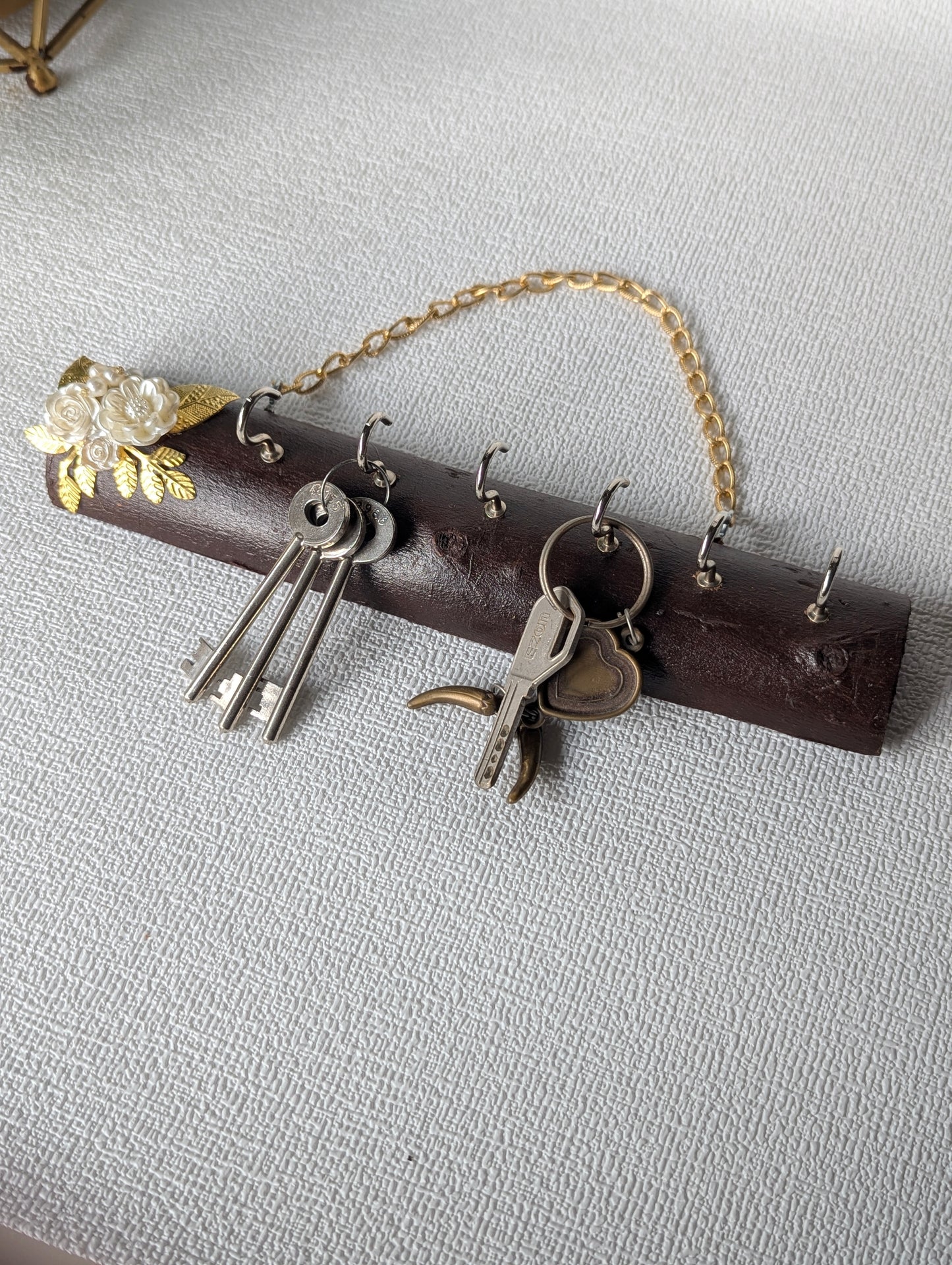 Handcrafted wooden key holder with gold chain and floral Mother of Pearl accents