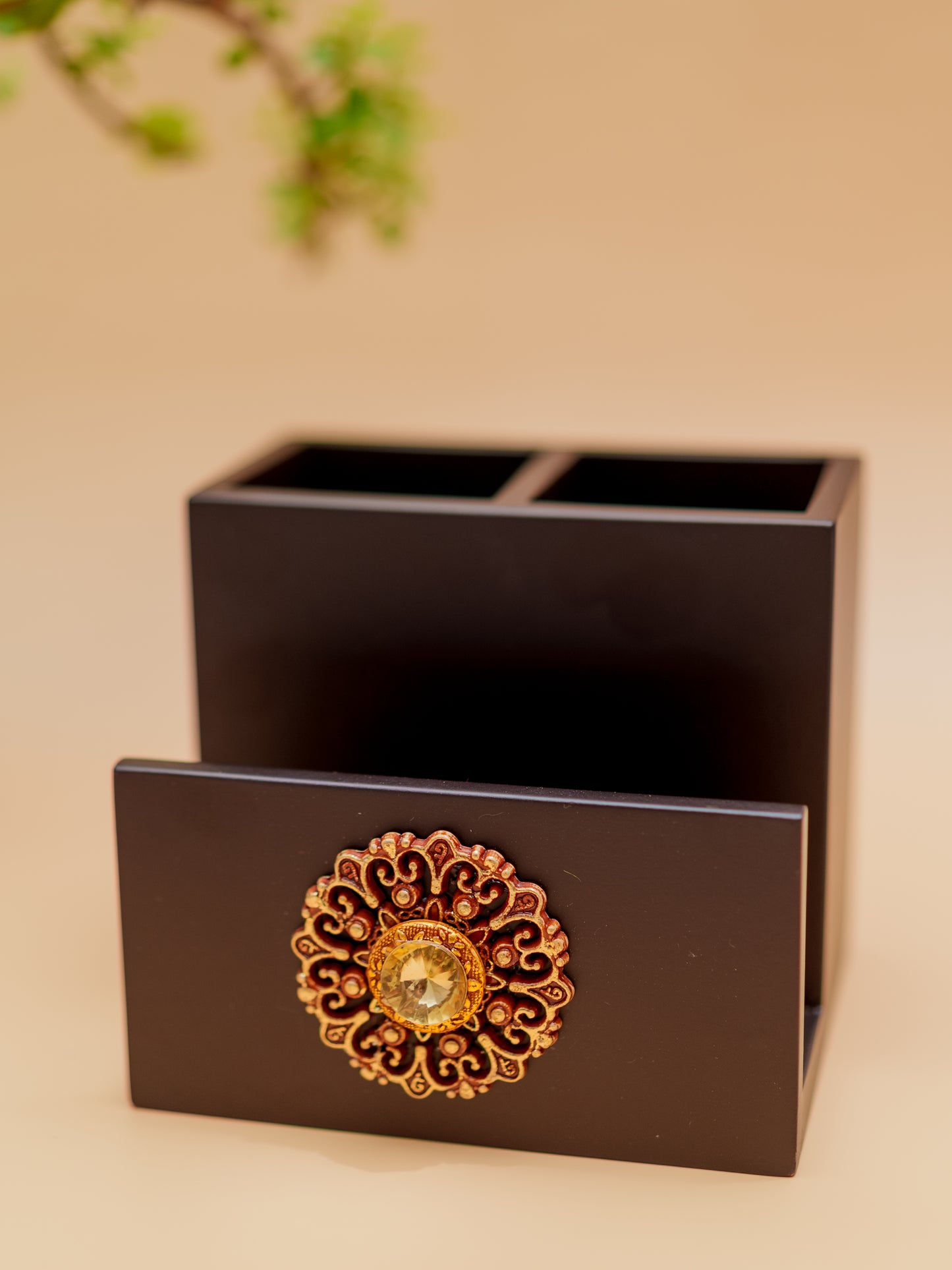 Handcrafted black wooden pen holder with ornate gold floral accent and gemstone