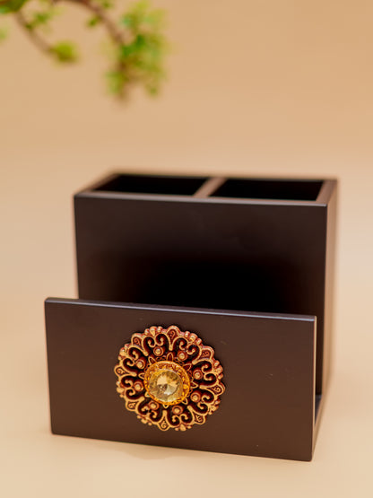 Handcrafted black wooden pen holder with ornate gold floral accent and gemstone