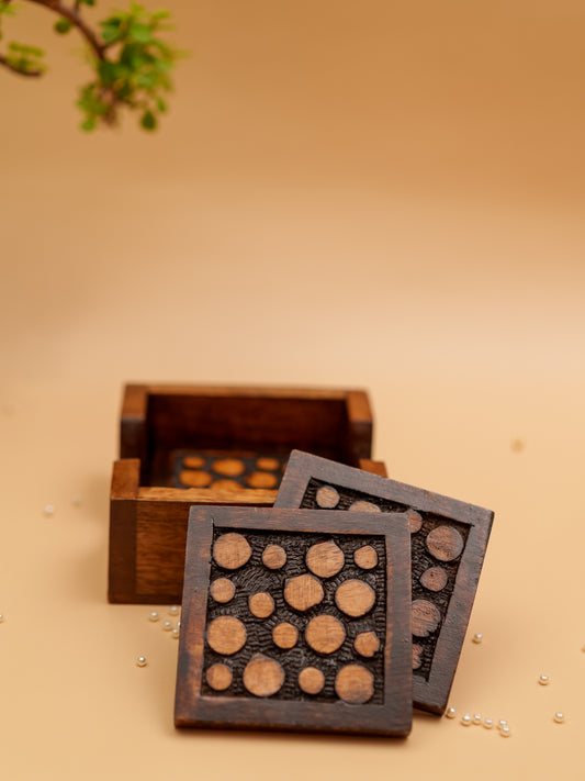 Handcrafted wooden coasters with circular pattern and matching storage box on beige background
