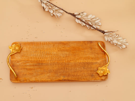 Handcrafted rectangular wooden tray with gold floral handles on a beige background
